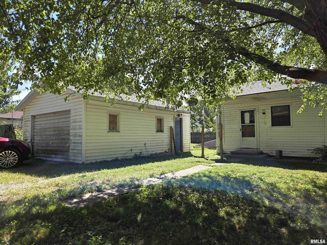 exterior space featuring a yard and a garage