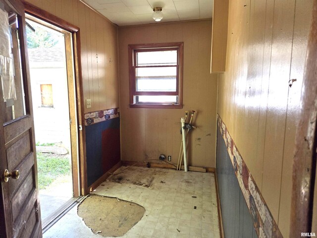 doorway featuring wood walls