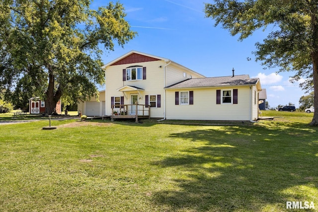 back of property featuring a lawn, a wooden deck, and a storage shed