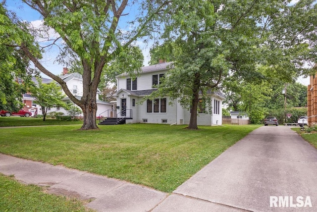 view of front of home featuring a front lawn, fence, driveway, and roof with shingles