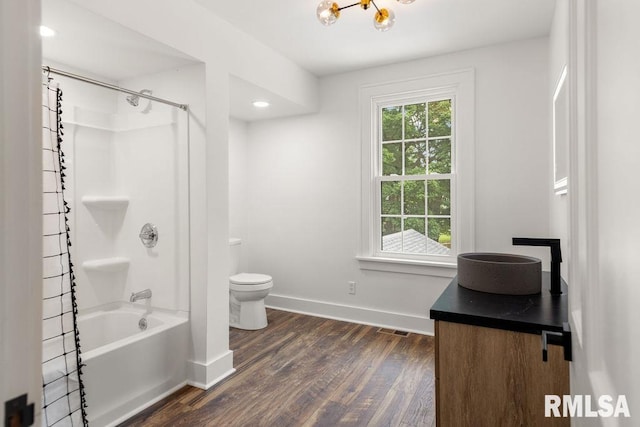 full bathroom with washtub / shower combination, wood-type flooring, toilet, and vanity