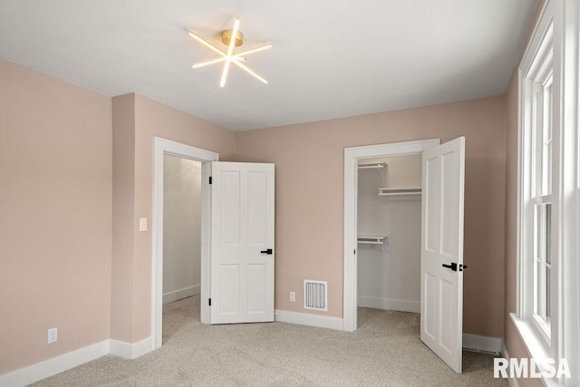 unfurnished bedroom with carpet flooring, visible vents, and baseboards