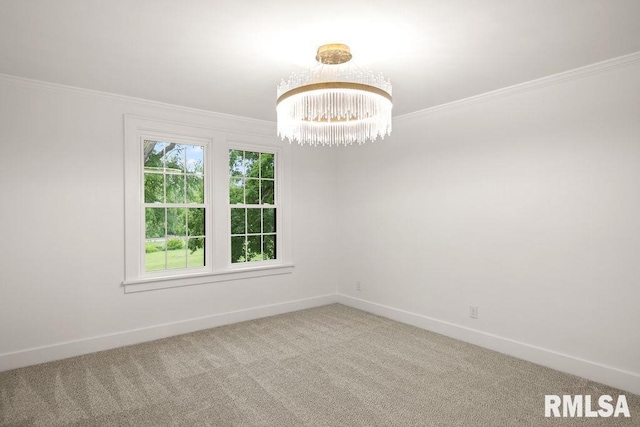 spare room with ornamental molding, carpet floors, baseboards, and an inviting chandelier