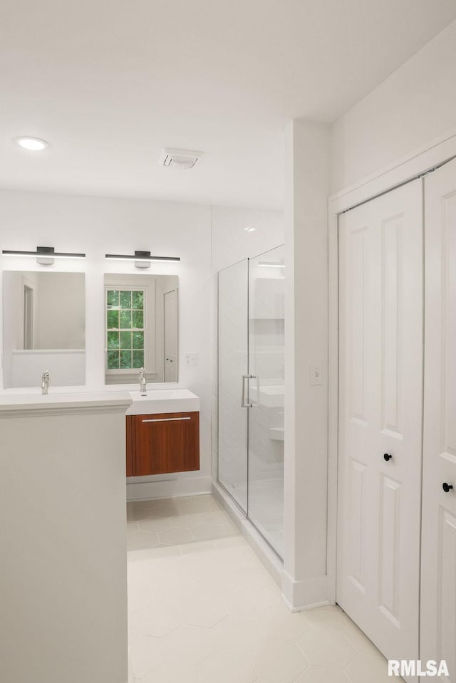 bathroom featuring a shower stall, tile patterned floors, and vanity