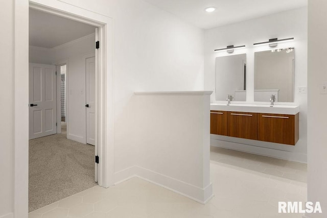 bathroom with crown molding and vanity