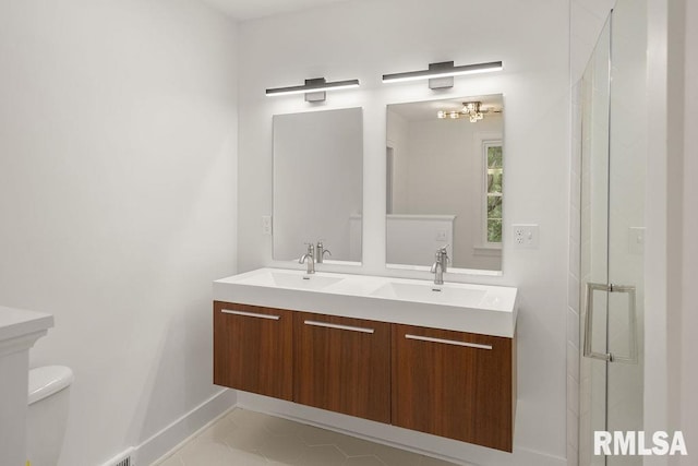 bathroom featuring vanity, toilet, an enclosed shower, and tile patterned flooring