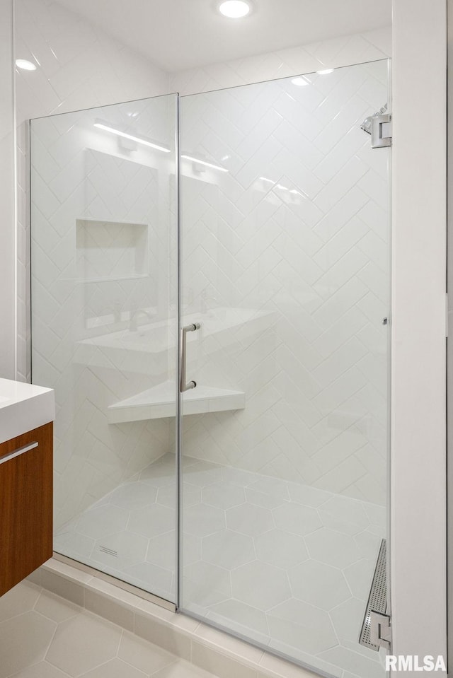 bathroom with vanity and a shower with shower door