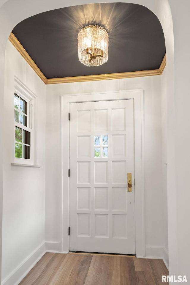 entrance foyer featuring an inviting chandelier and wood-type flooring