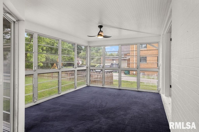 unfurnished sunroom featuring ceiling fan