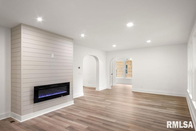 unfurnished living room featuring light wood-type flooring