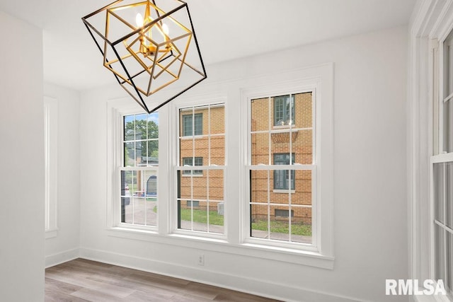 interior space with an inviting chandelier and wood-type flooring