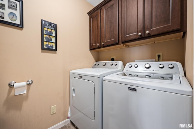 washroom featuring washing machine and dryer and cabinets