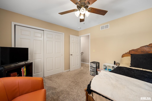 carpeted bedroom with a closet and ceiling fan