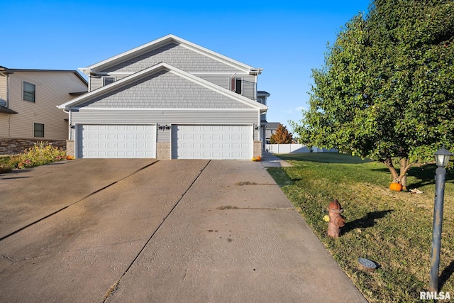 view of front of home with a front lawn and a garage