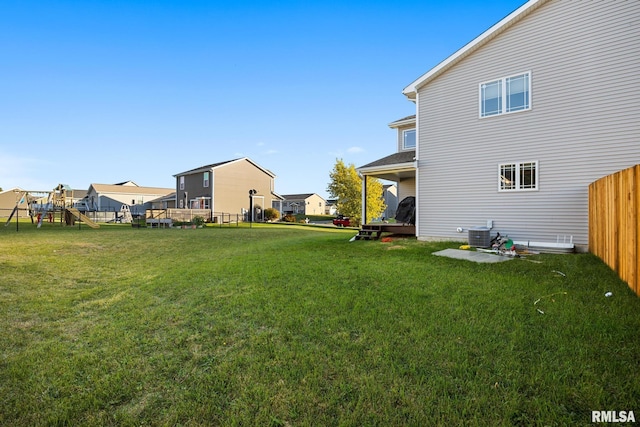 view of yard with a playground and central AC unit