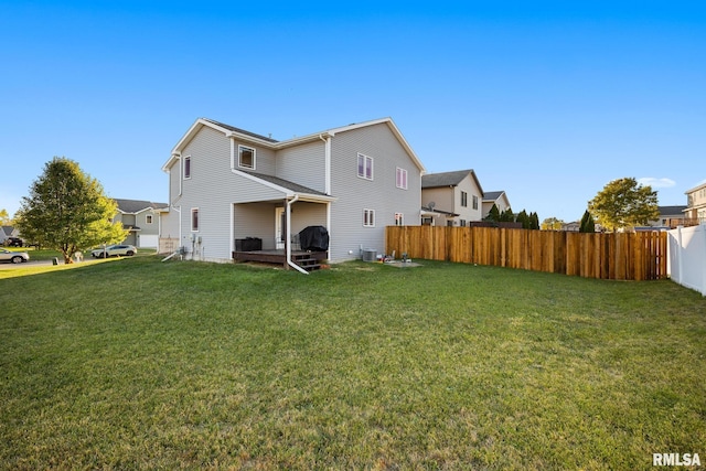 rear view of property with a lawn