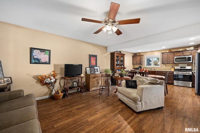 living room with ceiling fan and dark hardwood / wood-style flooring