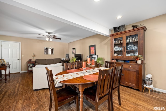 dining room with ceiling fan and dark hardwood / wood-style flooring