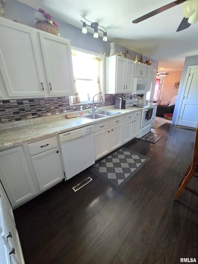 kitchen featuring white appliances, dark wood-type flooring, sink, ceiling fan, and white cabinets