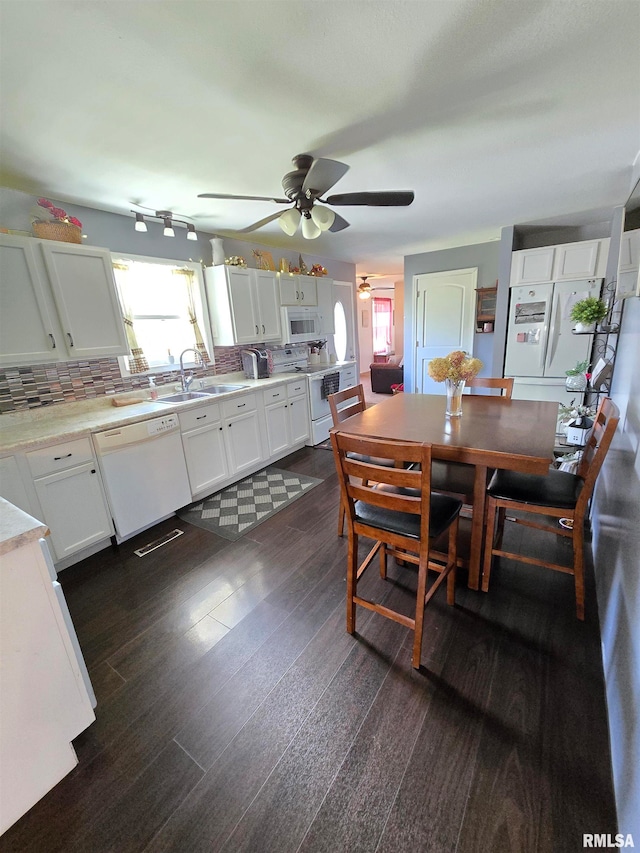 dining area with dark hardwood / wood-style flooring, sink, and ceiling fan