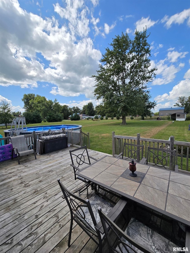 wooden terrace with a hot tub and a yard