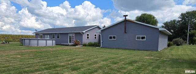 rear view of property featuring a yard