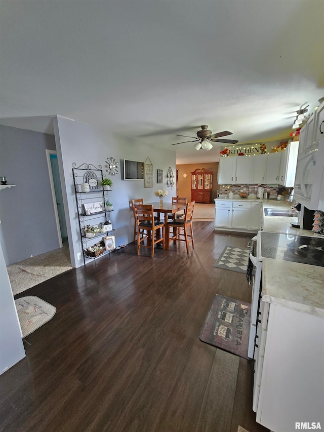 kitchen featuring white cabinetry, white appliances, dark hardwood / wood-style flooring, and ceiling fan