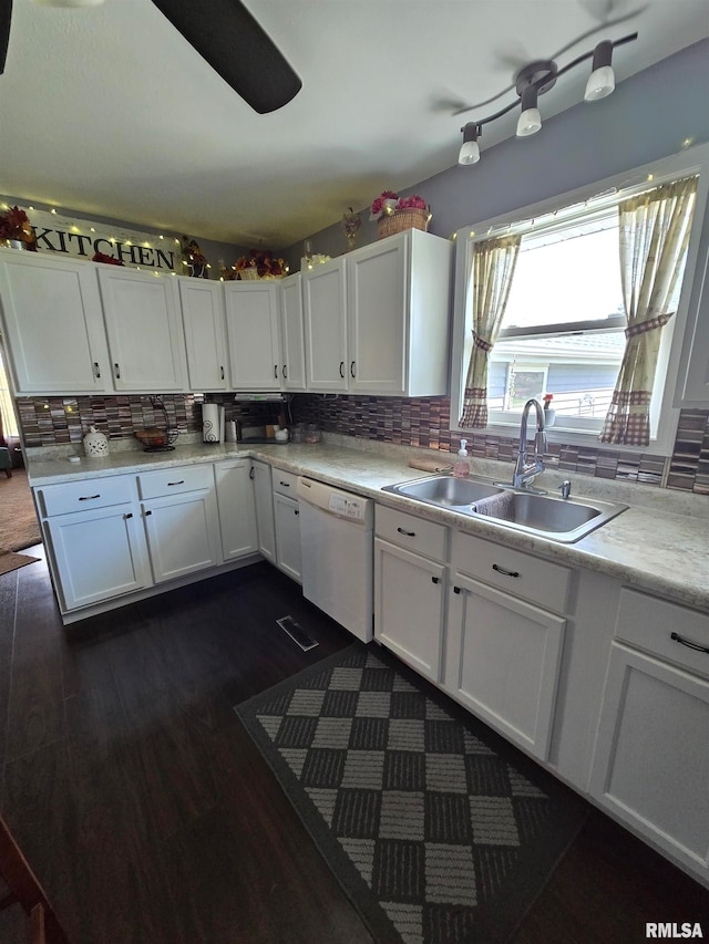 kitchen with dark hardwood / wood-style floors, dishwasher, backsplash, sink, and white cabinetry