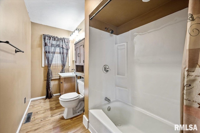 full bathroom with toilet, vanity, hardwood / wood-style flooring, and  shower combination