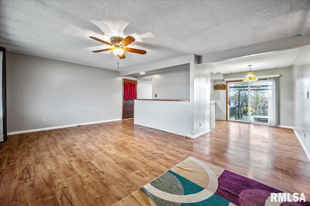 unfurnished living room with hardwood / wood-style flooring, ceiling fan, and a textured ceiling