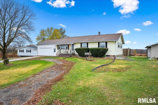 ranch-style home with a garage and a front yard