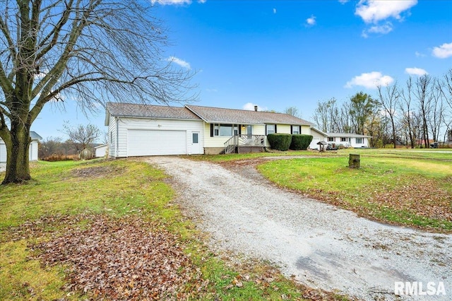 ranch-style home with a front lawn, a garage, and covered porch