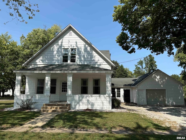 view of front of property with a garage, a porch, and a front lawn