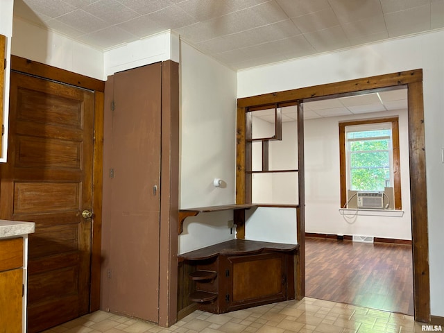 interior space featuring cooling unit and light hardwood / wood-style floors