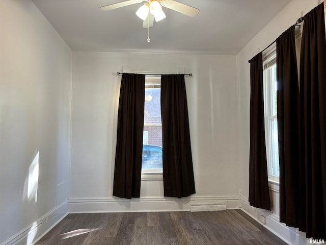 empty room with hardwood / wood-style floors, ceiling fan, and a healthy amount of sunlight