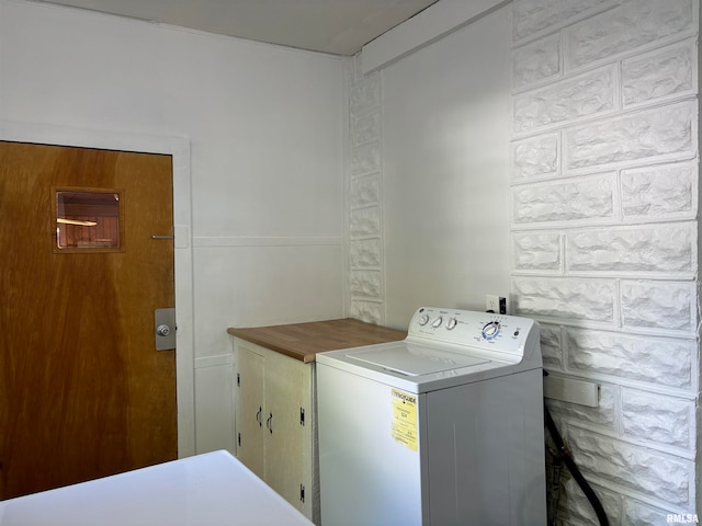 laundry room with cabinets and washer / dryer