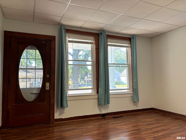 foyer entrance featuring plenty of natural light, hardwood / wood-style flooring, and a paneled ceiling