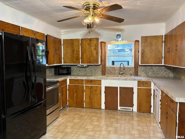 kitchen with black appliances, backsplash, sink, and ceiling fan