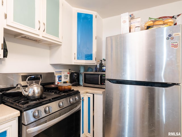 kitchen with appliances with stainless steel finishes and white cabinetry