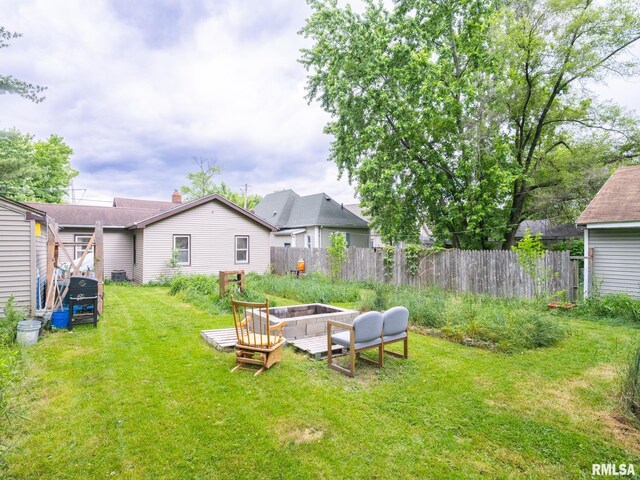 view of yard with a fire pit