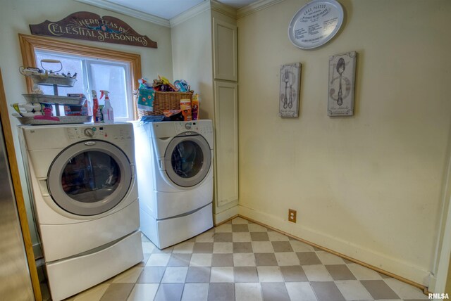 washroom featuring cabinets, washer and clothes dryer, and crown molding