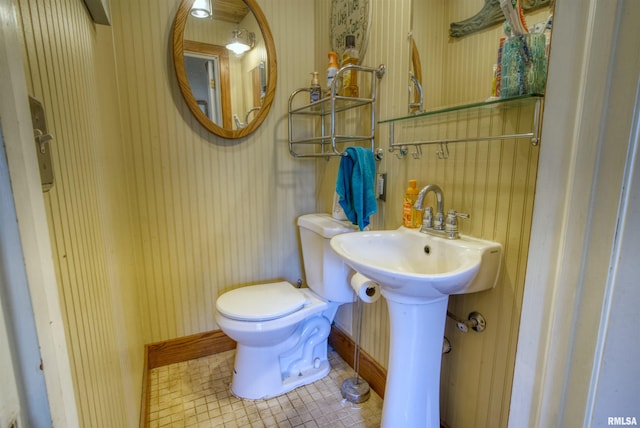 bathroom with tile patterned flooring, toilet, and sink