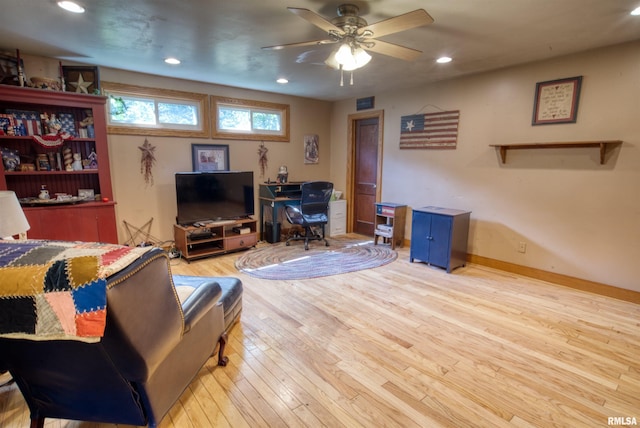 living room with ceiling fan and light hardwood / wood-style floors