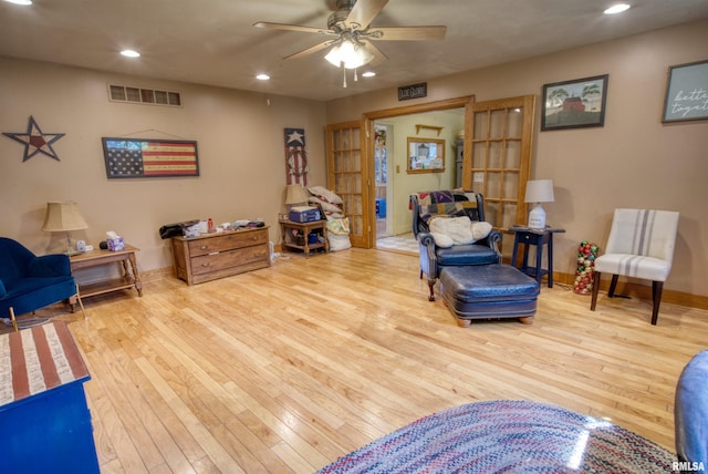 living room featuring ceiling fan and light wood-type flooring