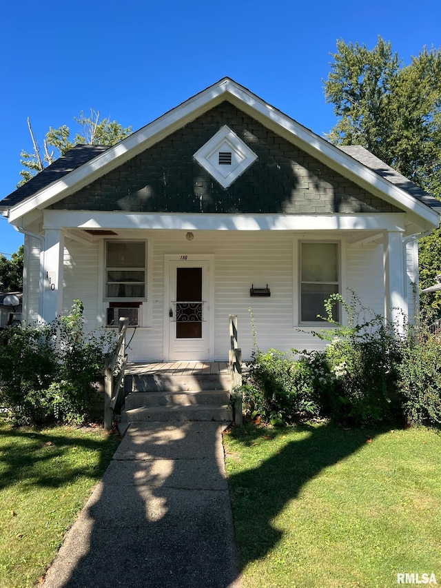 bungalow-style house with a front yard and a porch