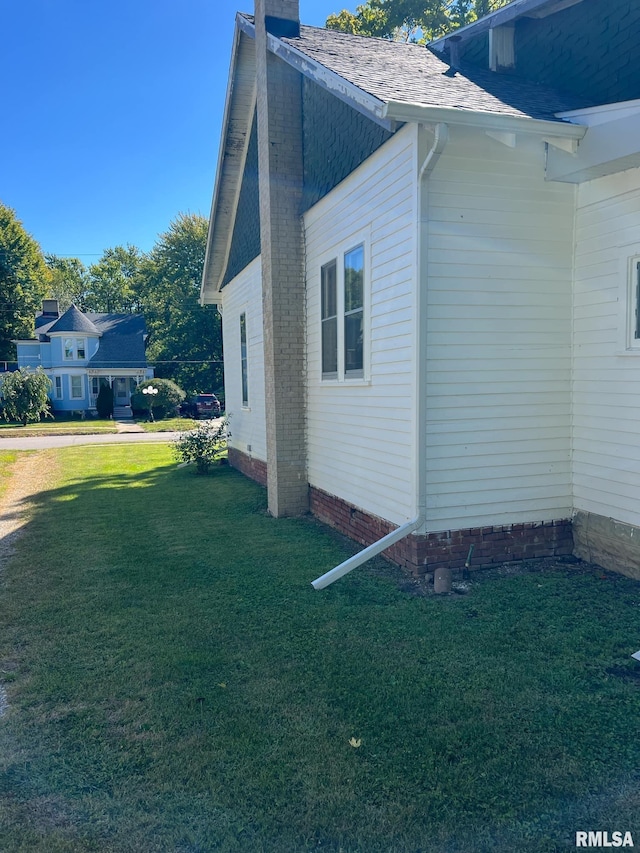 view of side of home featuring a lawn