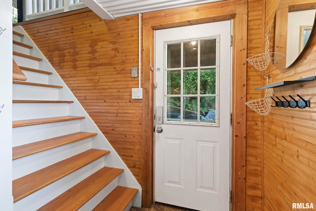 doorway featuring wooden walls