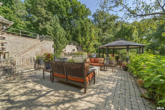 200 W Ravinwoods Rd, Peoria, IL 61615 - view of patio / terrace featuring an outdoor hangout area, a gazebo, stairs, and view of scattered trees
