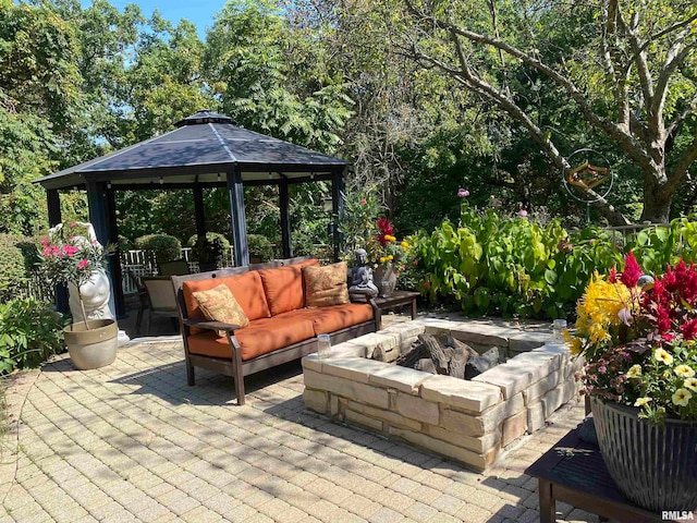 200 W Ravinwoods Rd, Peoria, IL 61615 - view of patio with a gazebo and an outdoor living space with a fire pit