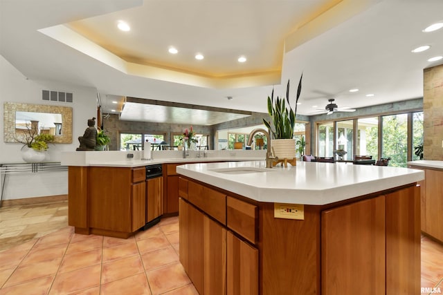 200 W Ravinwoods Rd, Peoria, IL 61615 - kitchen featuring a sink, light countertops, brown cabinetry, recessed lighting, and a raised ceiling